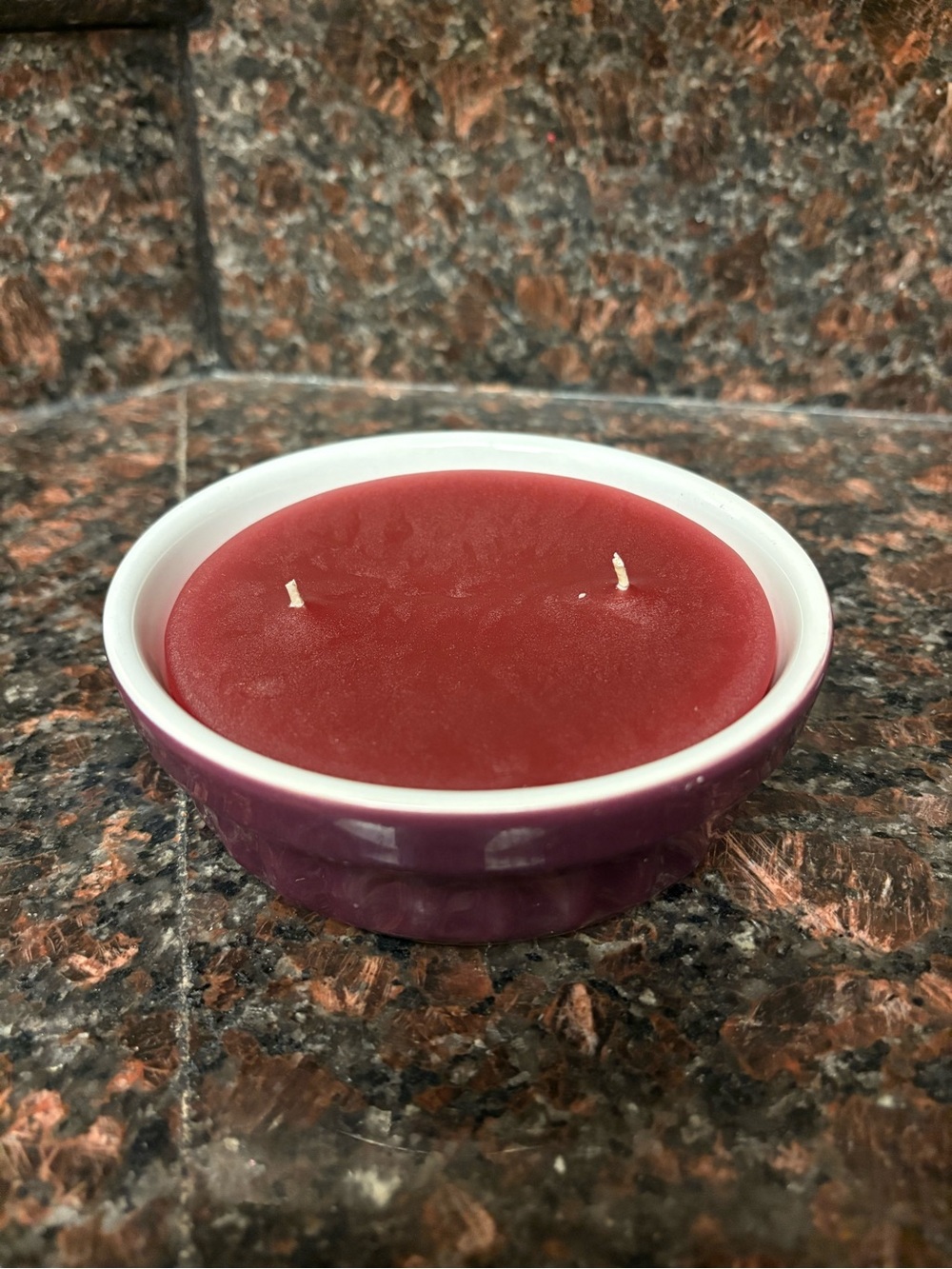Handmade upcycled candle apple cherry scent wax in a thrifted purple glass dish